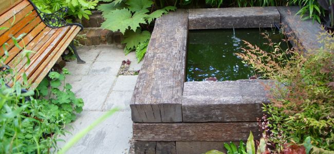 Raised pond & water feature built from used tropical hardwood railway sleepers. Railwaysleepers.com 