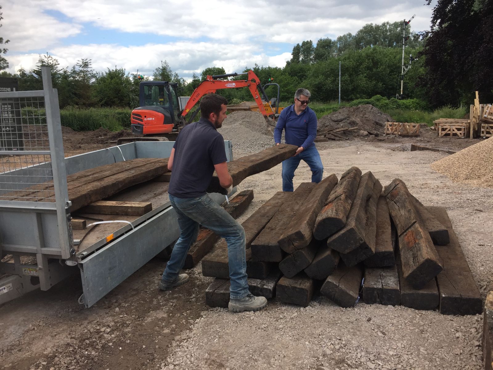 Manually lifting old heavy railway sleepers off a trailer can be tough work! Railwaysleepers.com