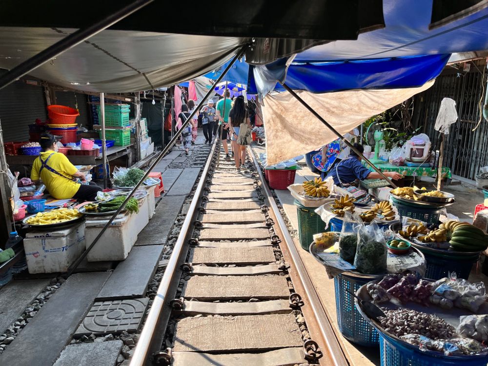 The train literally runs through the centre of Mae Klong market in Thailand, as people walk along the railway sleepers. Railwaysleepers.com