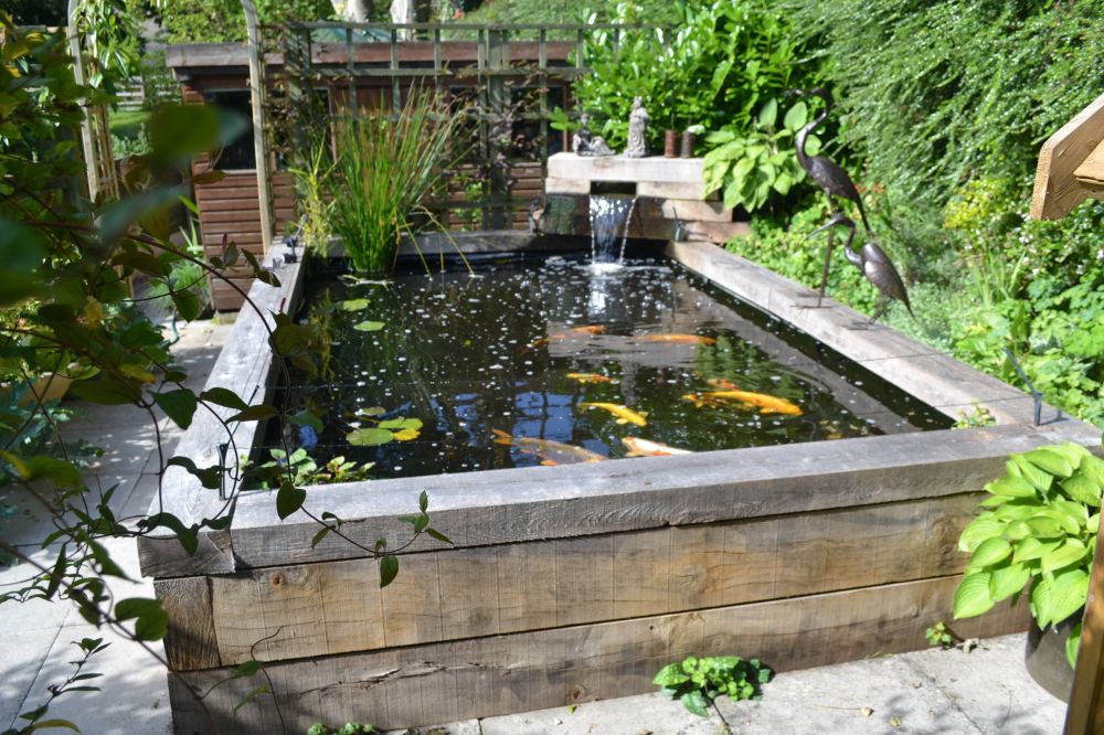 Raised Koi pond made from new oak railway sleepers. Railwaysleepers.com