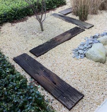 Used hardwood railway sleepers placed on the ground as landscaping feature