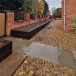 AN EYE-CATCHING BOUNDARY OF RAISED BEDS FROM RECLAIMED AZOBE RAILWAY SLEEPERS