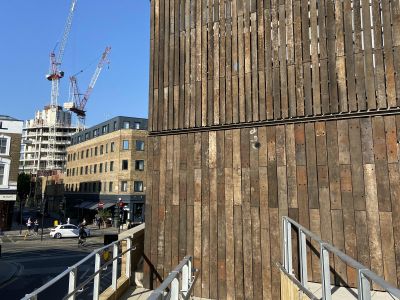 ICONIC CAMDEN ROUNDHOUSE THEATRE CLAD WITH RECLAIMED TROPICAL HARDWOOD RAILWAY SLEEPERS