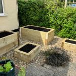 A VARIED COLLECTION OF RAISED PLANTERS FROM NEW PINE RAILWAY SLEEPERS