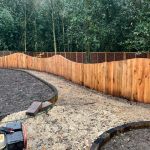CURVED PLAQUE WALL MADE FROM RAILWAY SLEEPERS IN HOSPITAL MEMORIAL GARDEN