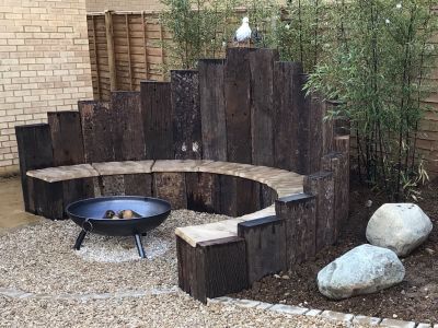 SARAH'S ATTRACTIVE GARDEN WITH CURVED RAILWAY SLEEPER BENCH AND RAISED BEDS