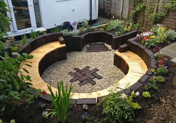 Curved seating area and landscaping with used hardwood railway sleepers. Railwaysleepers.com
