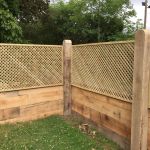 New Oak Railway Sleeper Wall Topped with Trellis Fencing