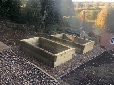 Building a vegetable bed from new British pine railway sleepers, at the very TOP of a garden