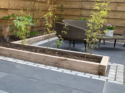 VIRTULAWN'S STYLISH PATIO AND LAWN EDGED WITH NEW OAK RAILWAY SLEEPERS