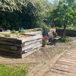THRUSSINGTON MILL'S RAISED BEDS AND WOODEN TRACK USING ANCIENT WEATHERED RAILWAY SLEEPERS