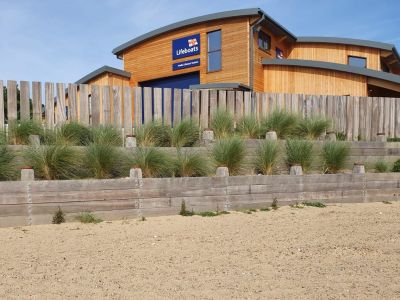 RAILWAY SLEEPER WALLS SURROUND THE NEW LIFEBOAT STATION AT WELLS-NEXT-THE-SEA