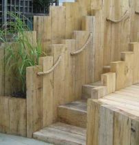Staggered retaining wall made from new oak railway sleepers